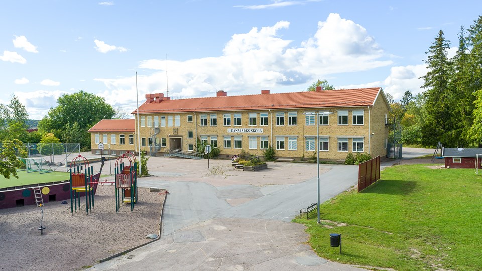 Överblick av Danmarks skolas byggnad och skolgård